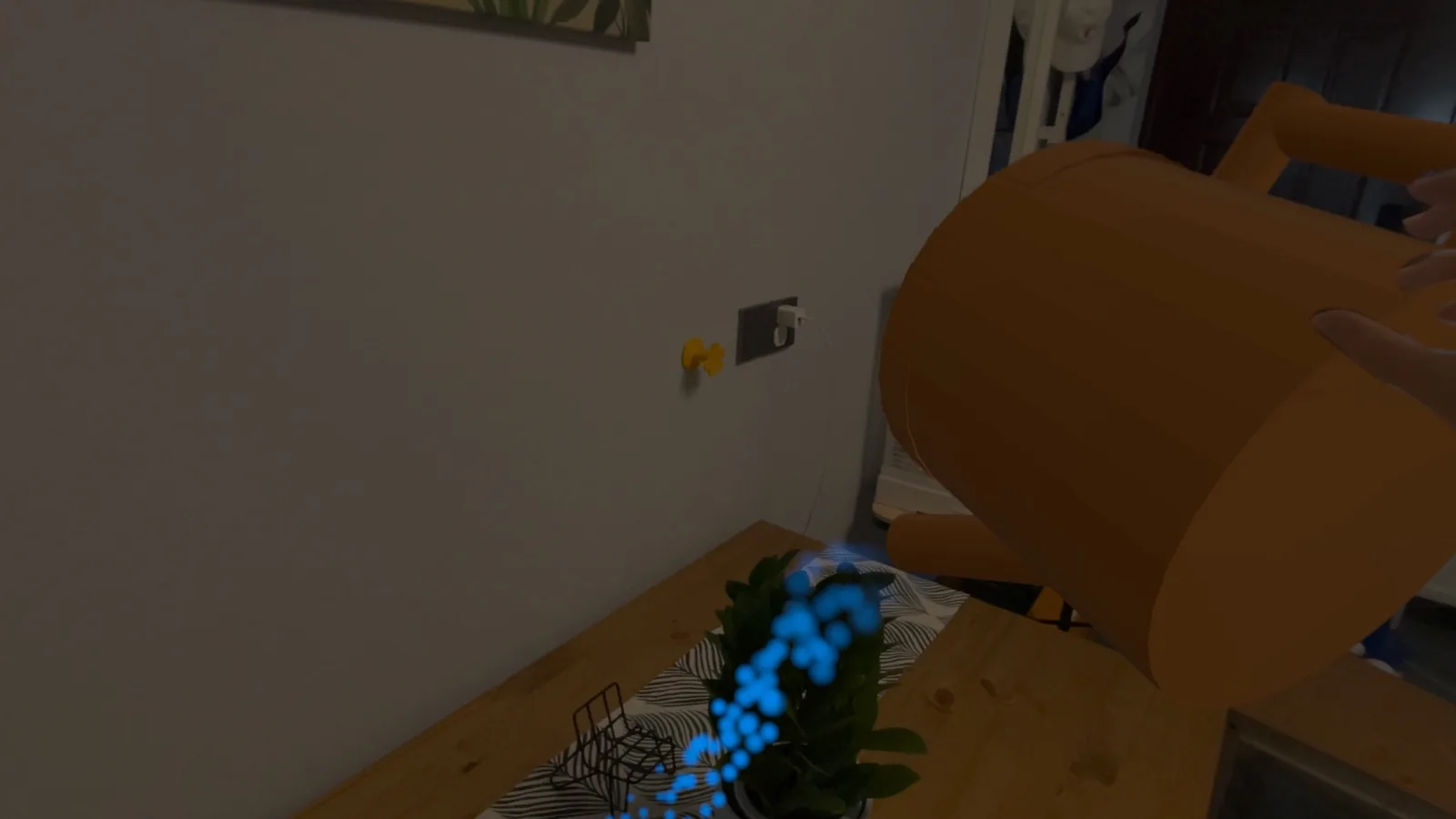 A watering can following the hand and pouring water over a plant